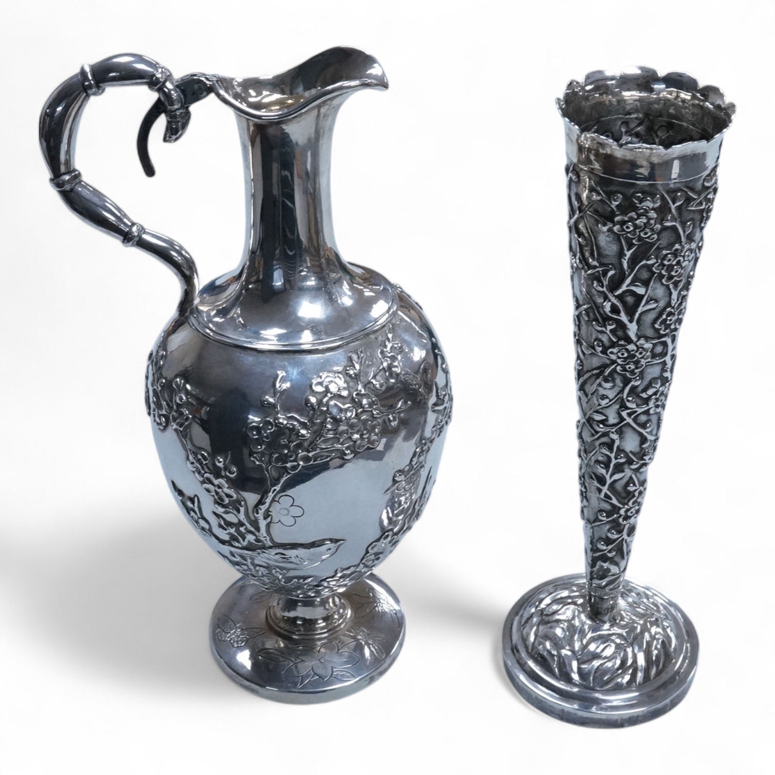 An early 20th century Chinese Export white metal posy vase, by Wang Hing, 18.4cm and a similar ewer by Tien Shing?, lacking cover.